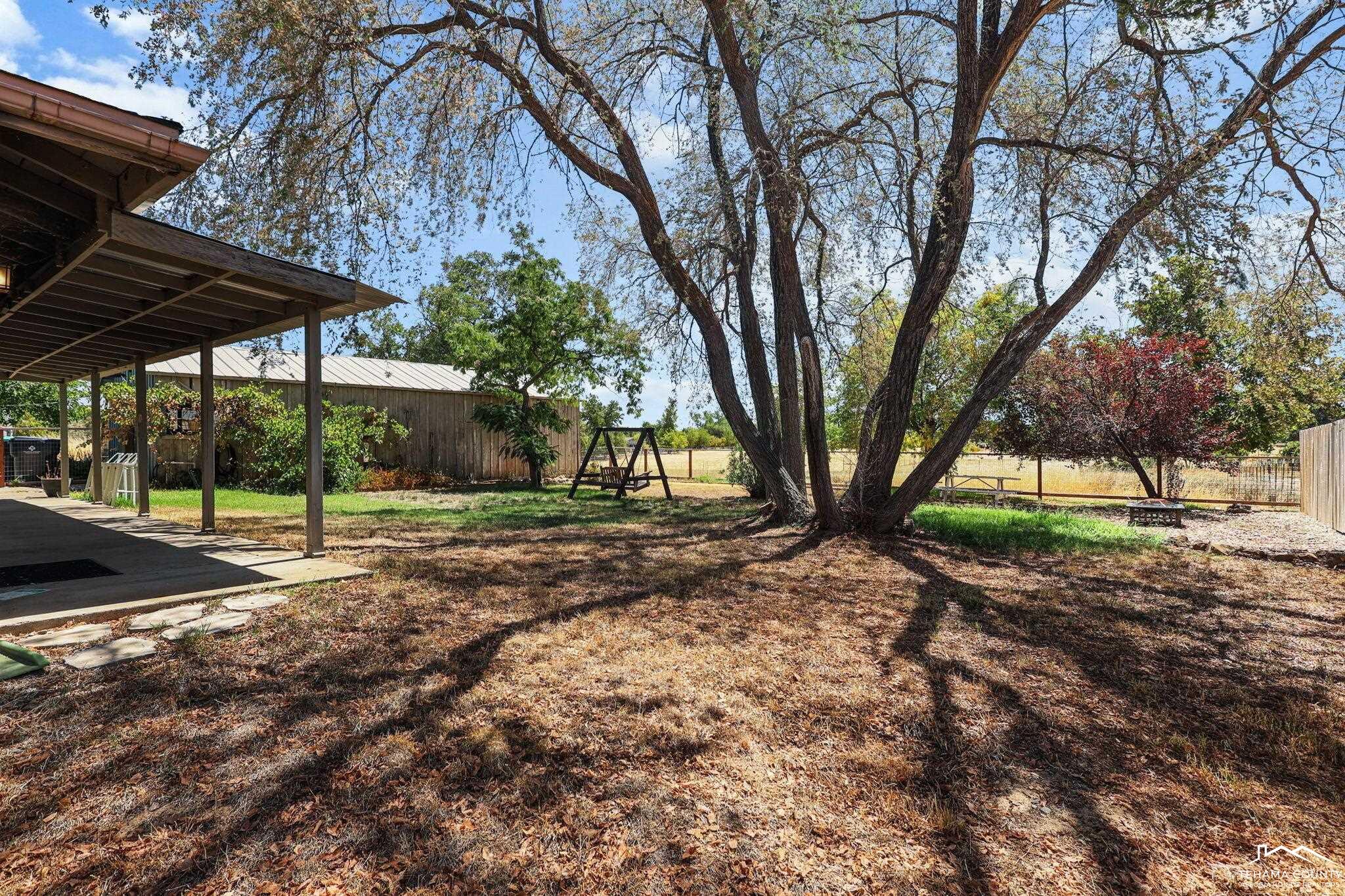 22275 Brent Road Red Bluff, CA 96080 - Photo 28 of 47 a view of a house with backyard and trees