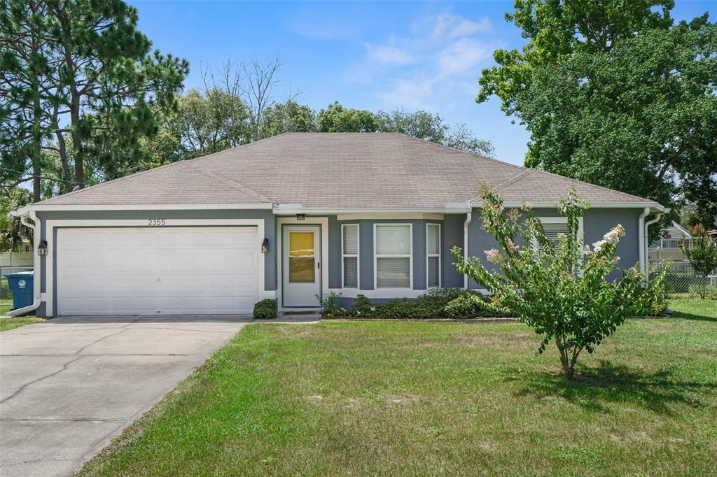 2355 Waterfall Drive Spring Hill, FL 34608 - Photo 1 of 1 a front view of a house with garden