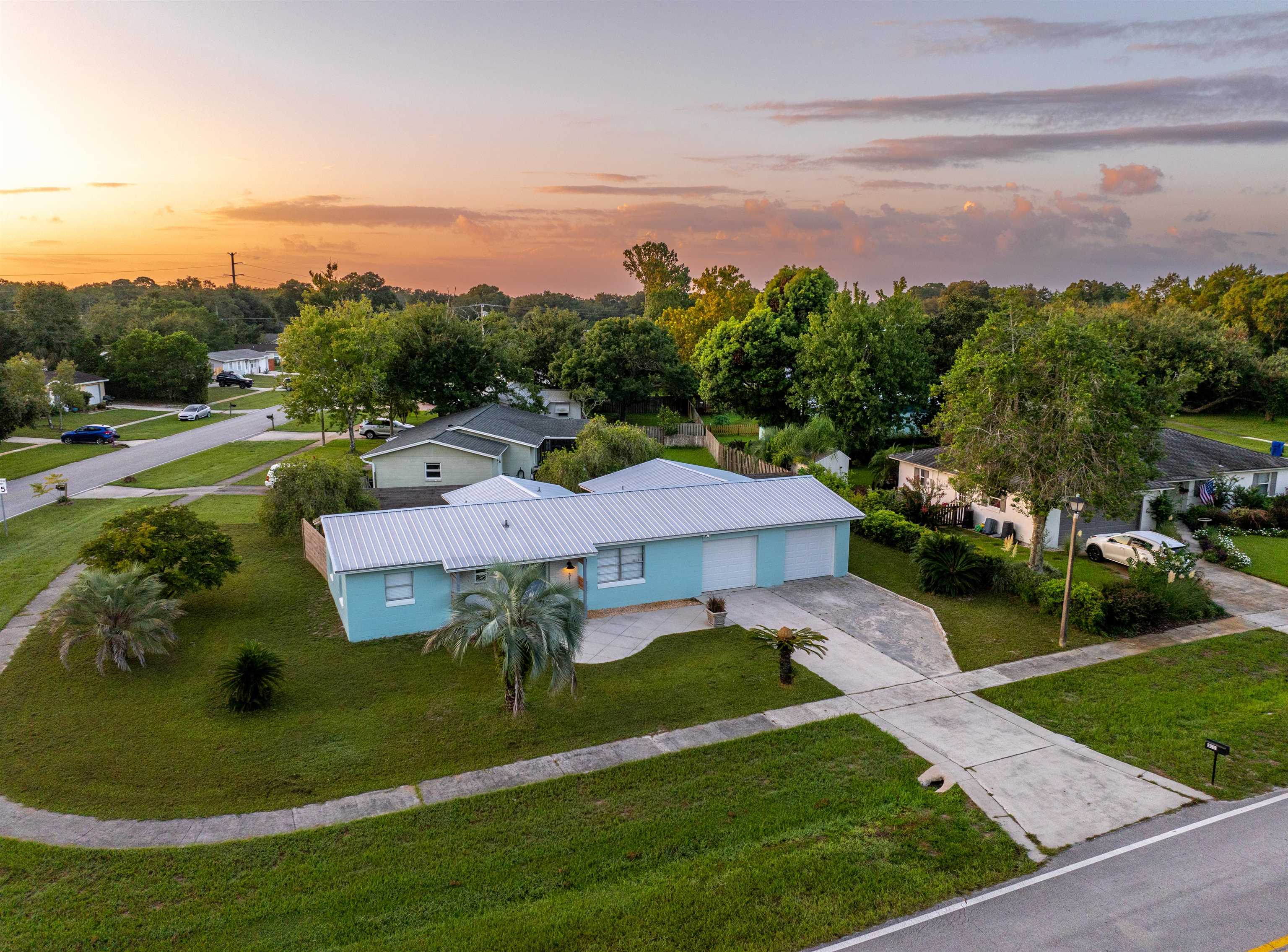 a aerial view of a house with garden and lake view