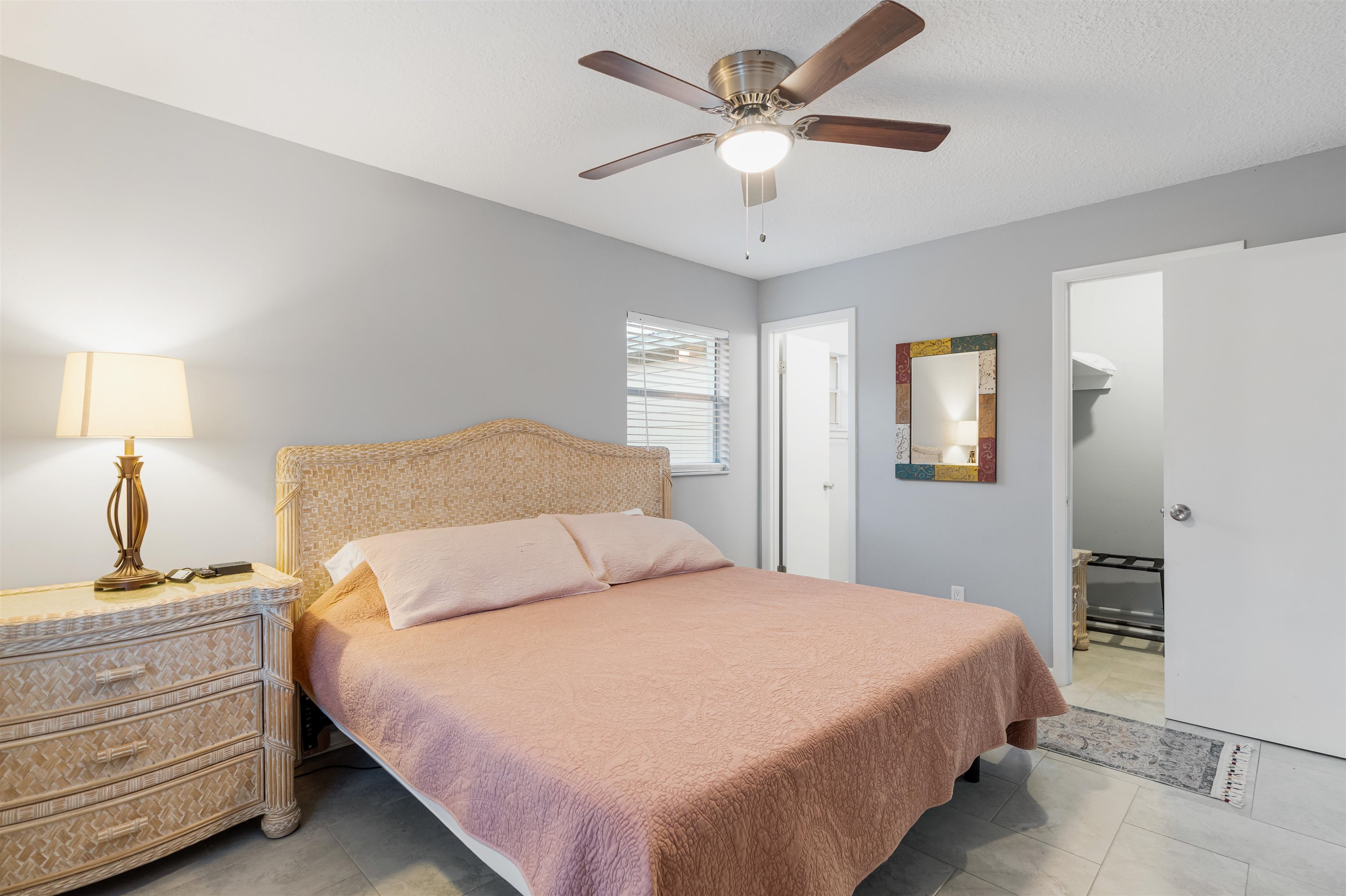 311 Deltona Boulevard St. Augustine, FL 32086 - Photo 12 of 16 a bedroom with a large bed and a chandelier