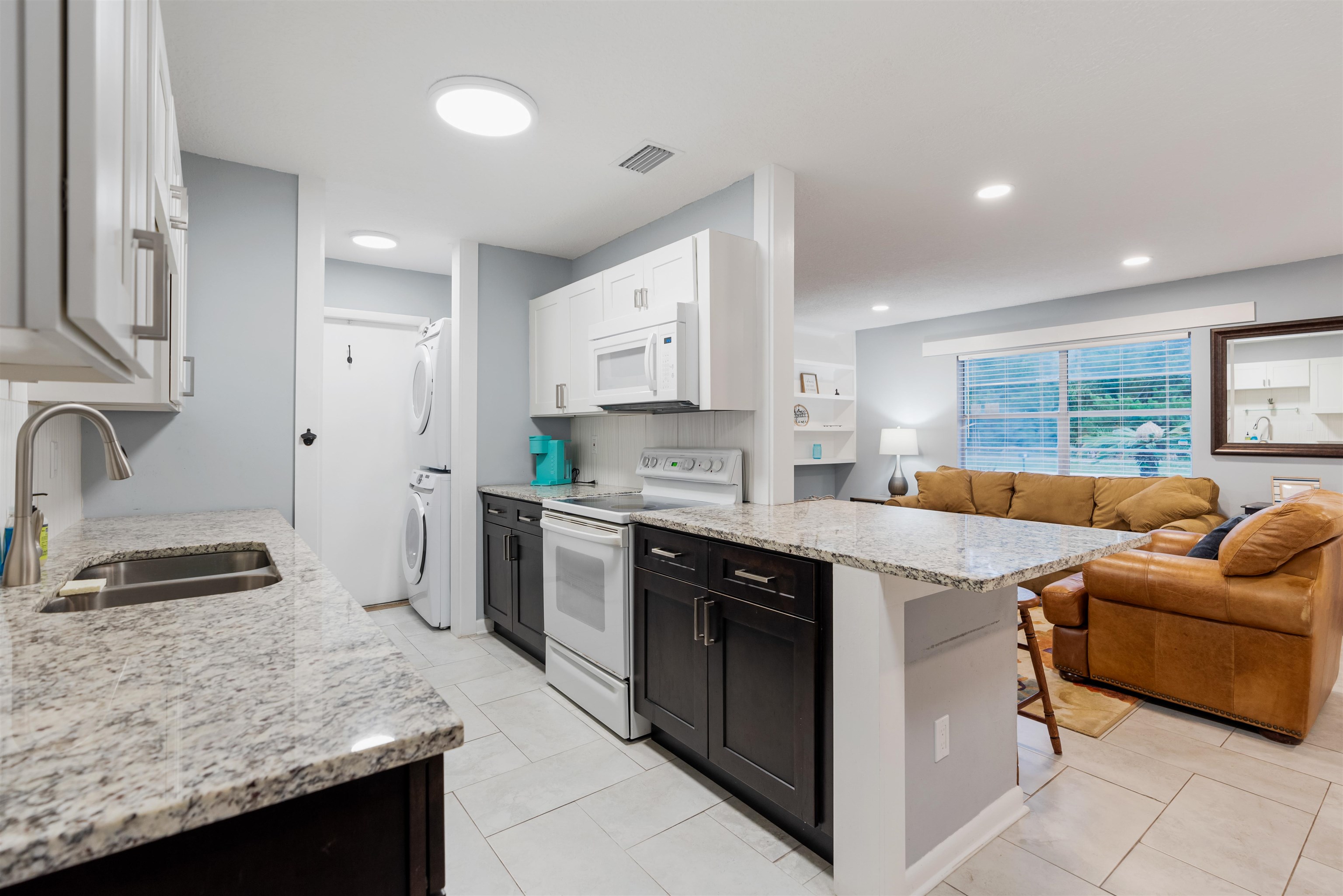 311 Deltona Boulevard St. Augustine, FL 32086 - Photo 6 of 16 a kitchen with granite countertop a sink a counter top space appliances and cabinets