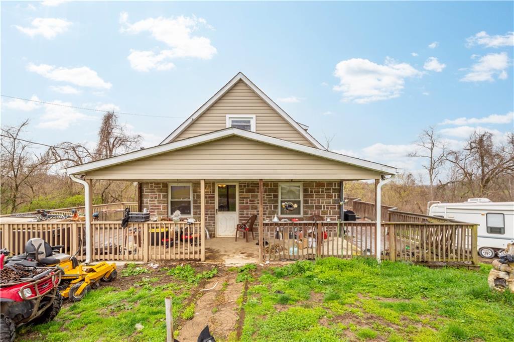 571 Highland Ridge Road Marianna, PA 15345 - Photo 1 of 25 a view of a house with a backyard and a patio