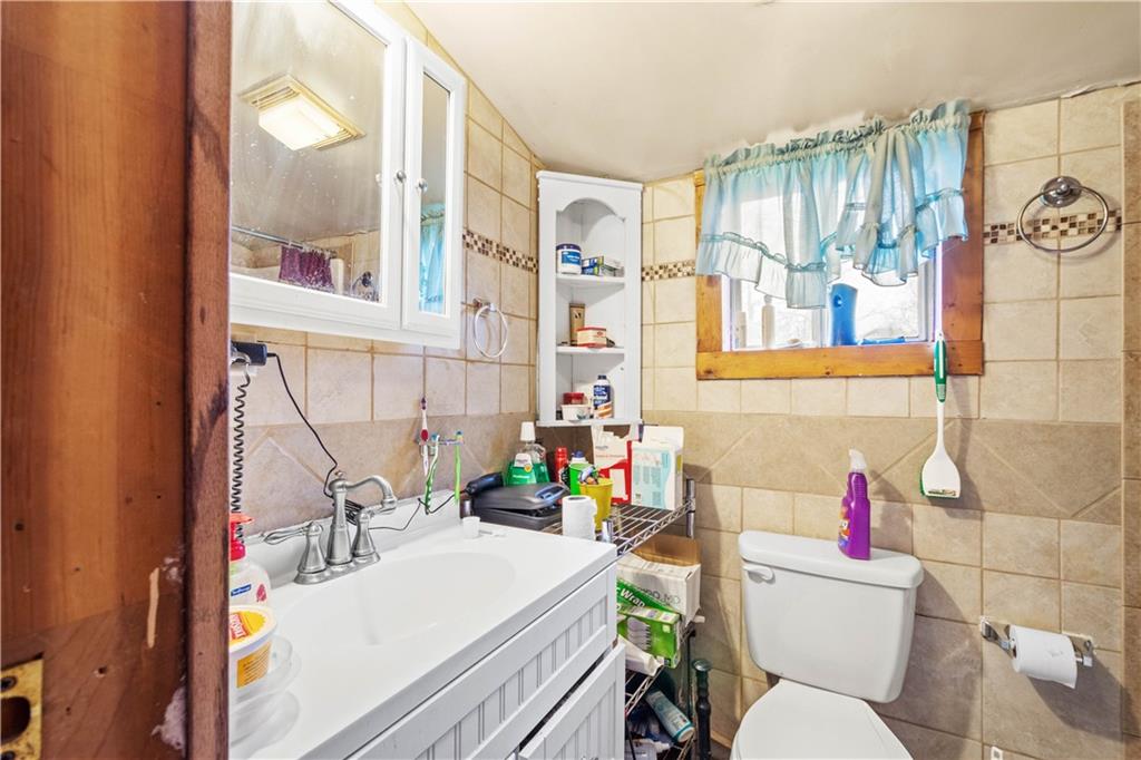 571 Highland Ridge Road Marianna, PA 15345 - Photo 11 of 25 a bathroom with a sink mirror vanity and toilet