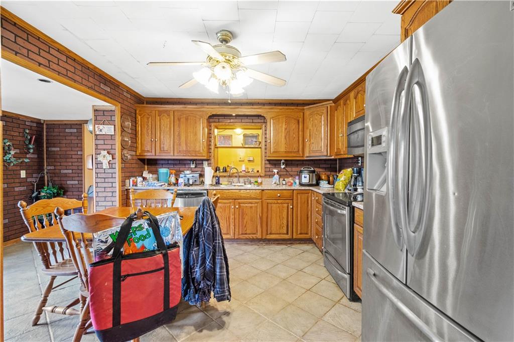 571 Highland Ridge Road Marianna, PA 15345 - Photo 7 of 25 a kitchen with stainless steel appliances granite countertop a refrigerator a sink a stove and island