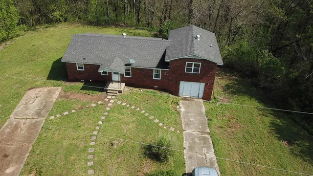 an aerial view of a house with a yard