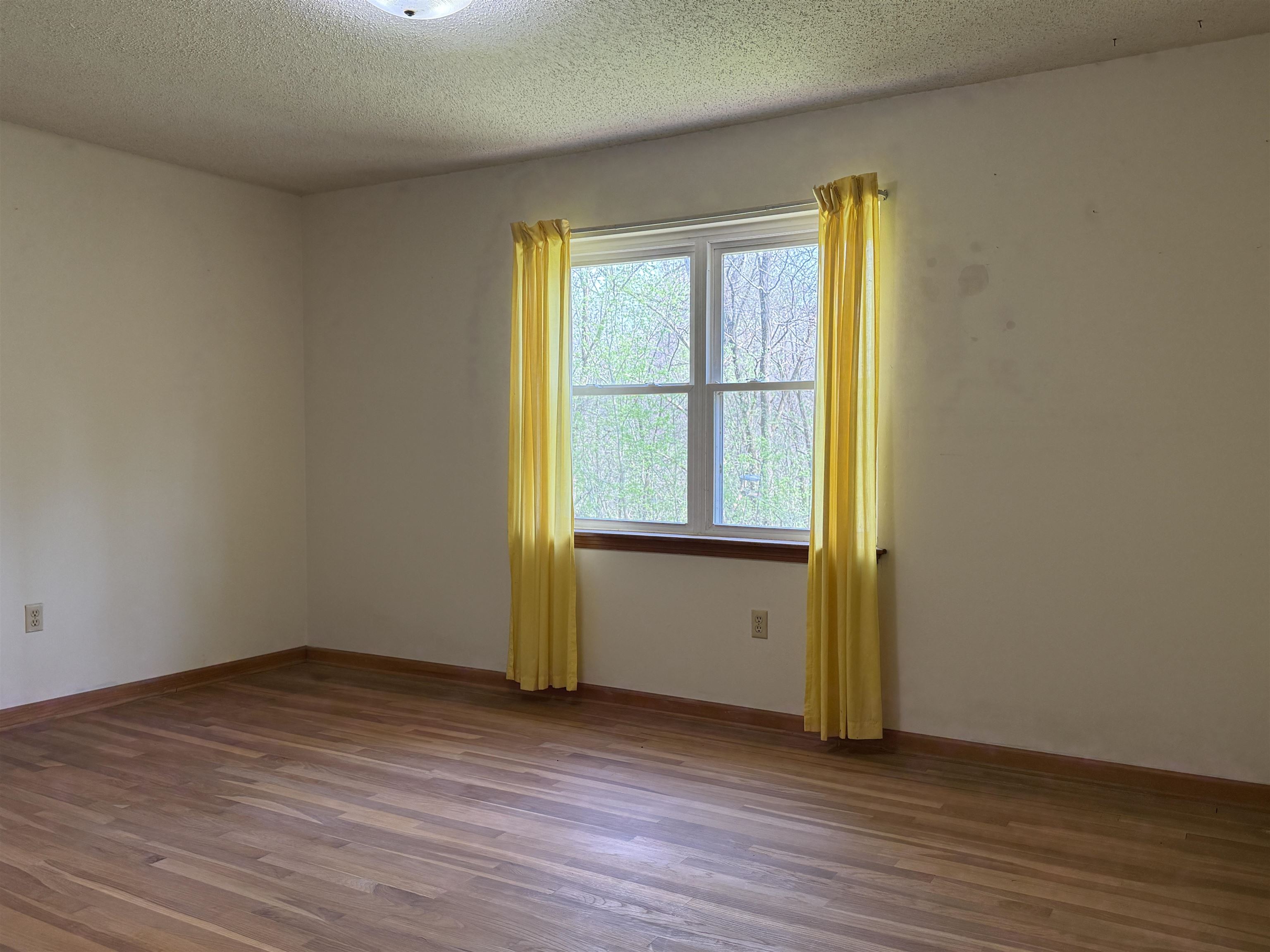 9640 New Bethel Road Millington, TN 38053 - Photo 15 of 22 a view of an empty room with wooden floor and a window