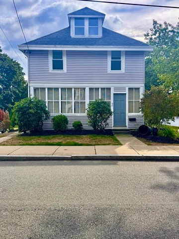 a view of house with a yard and plants