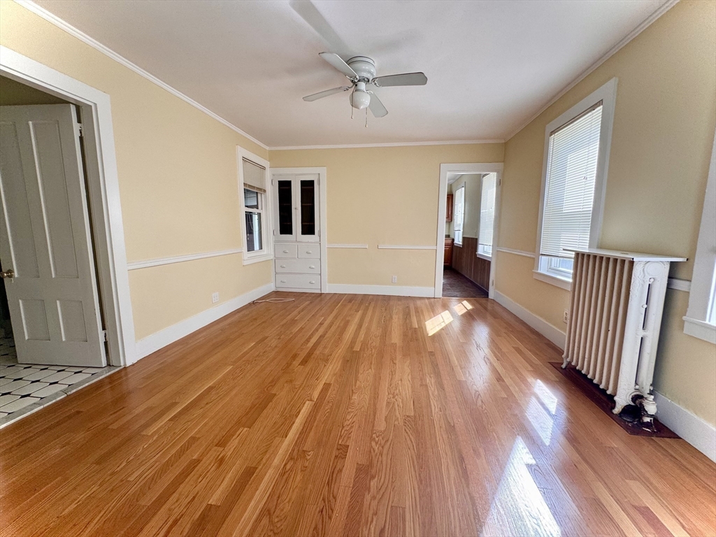 57 Adams Avenue Newton, MA 02465 - Photo 11 of 38 wooden floor in an empty room with a window