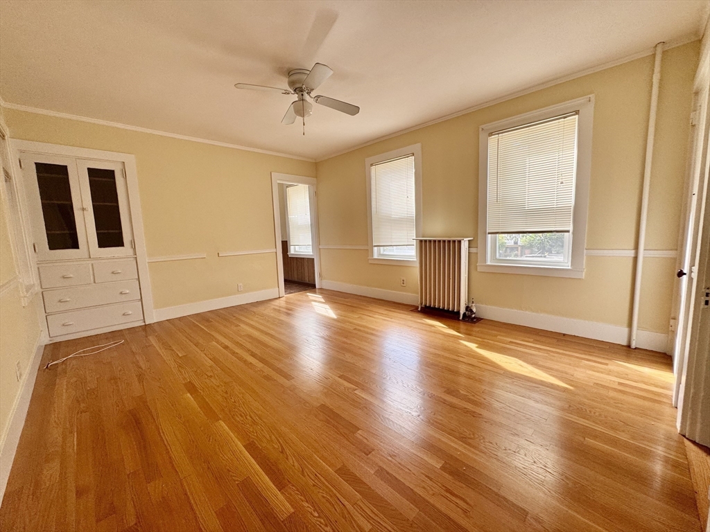 57 Adams Avenue Newton, MA 02465 - Photo 13 of 38 a view of an empty room with a window and wooden floor