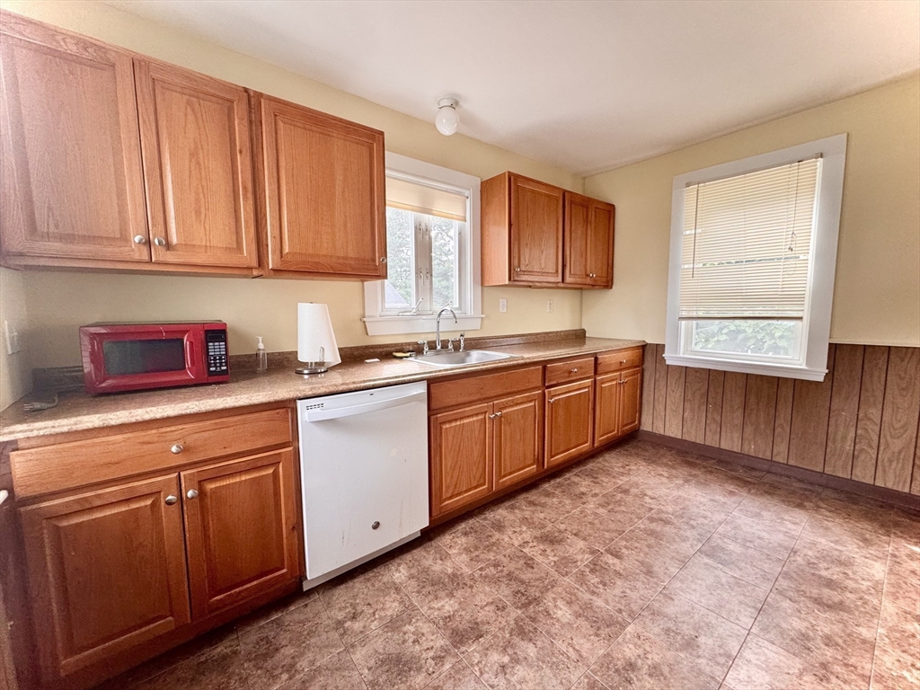 57 Adams Avenue Newton, MA 02465 - Photo 17 of 38 a kitchen with a sink window and cabinets