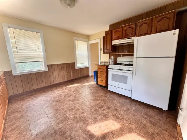 a kitchen with stainless steel appliances a refrigerator sink and microwave