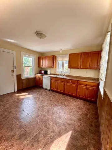 a kitchen with stainless steel appliances a stove top oven a sink dishwasher and a refrigerator