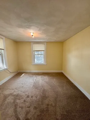 an empty room with a empty space and windows