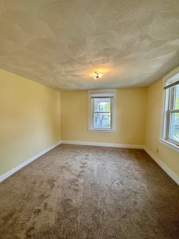 an empty room with a empty space and windows