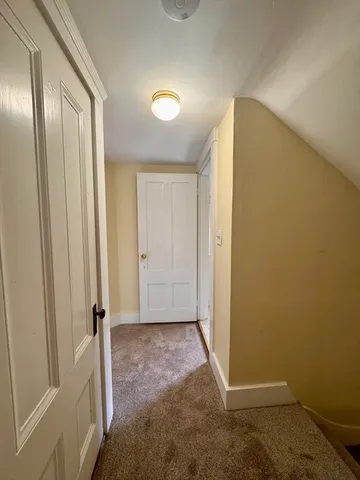 a view of empty room with a fireplace