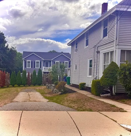 a front view of house with yard and trees