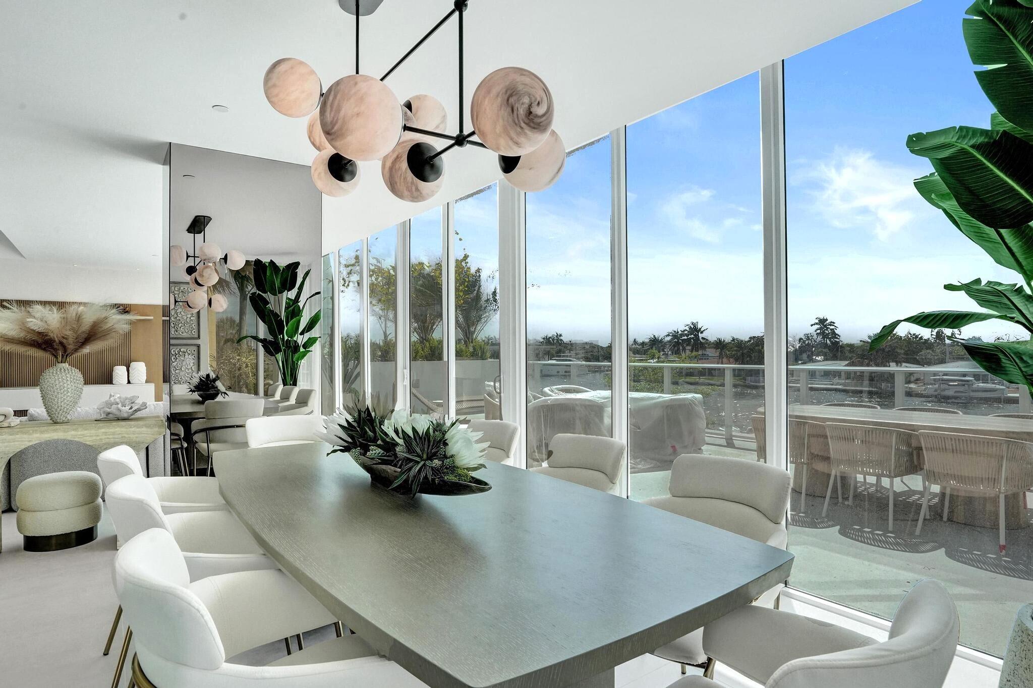 407 North Riverside Drive, Unit 203 Pompano Beach, FL 33062 - Photo 19 of 69 a view of a dining room with furniture wooden floor and chandelier