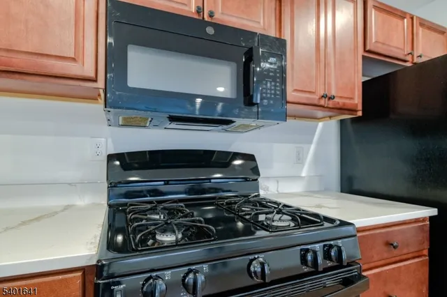 a stove top oven sitting inside of a kitchen