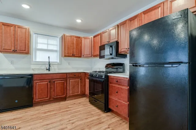 a kitchen with stainless steel appliances granite countertop a refrigerator and a sink
