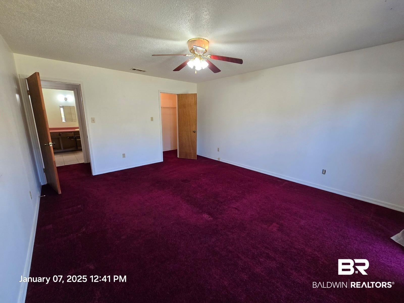 154 Byrd Road Monroeville, AL 36460 - Photo 20 of 26 Unfurnished bedroom with dark carpet, ensuite bath, a textured ceiling, and ceiling fan