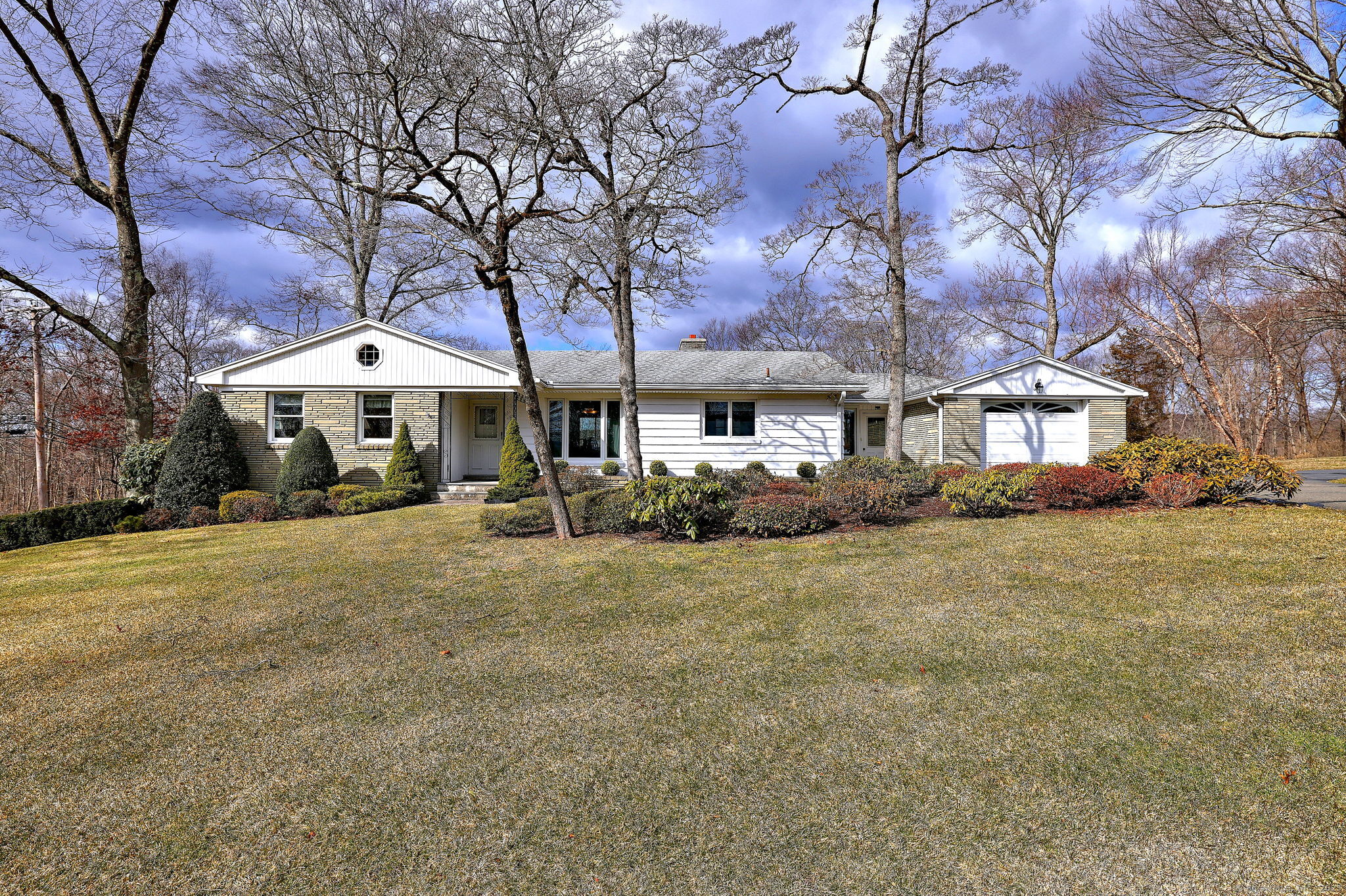 a patio with a table and chairs under an umbrella