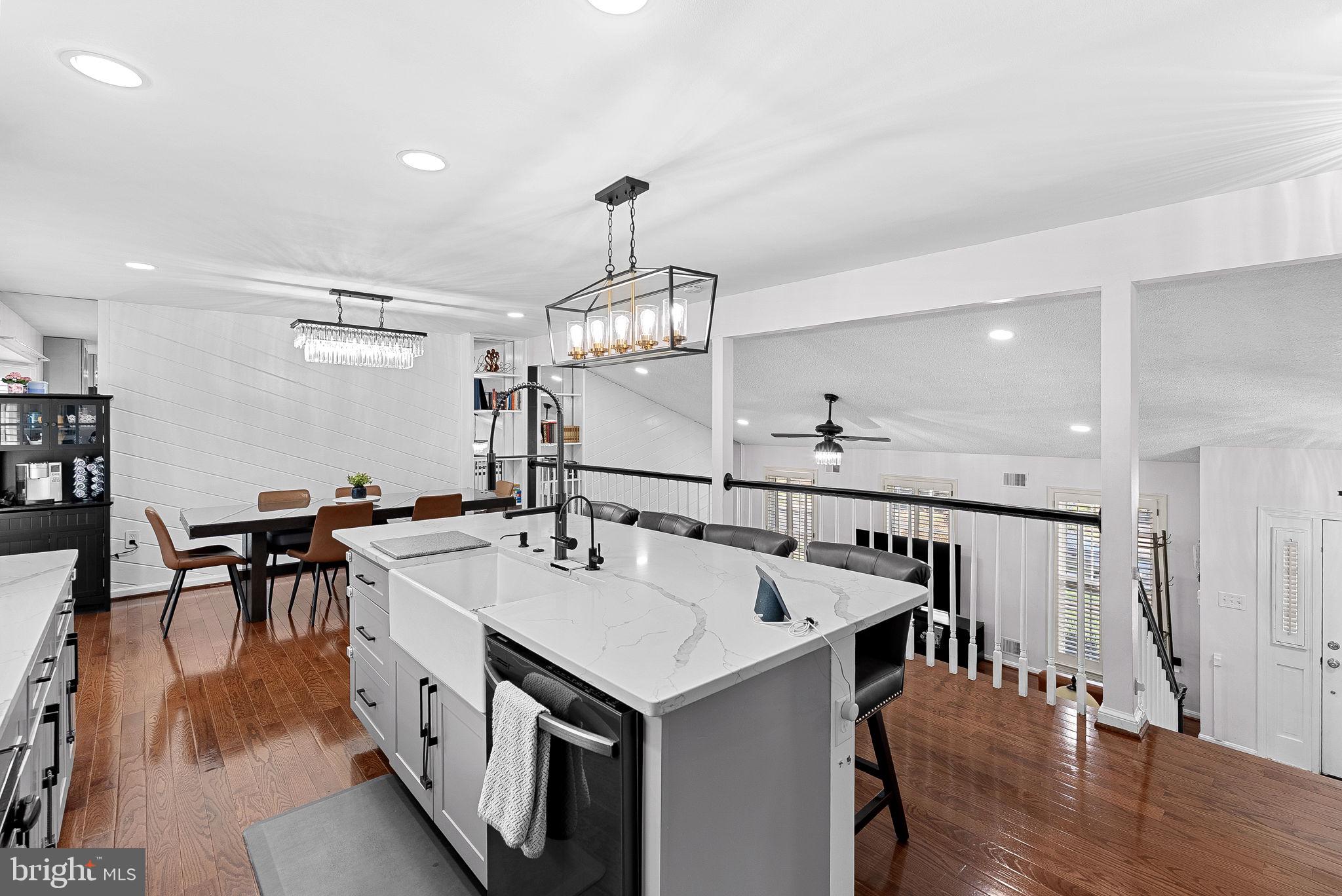 6208 Ormandy Drive Burke, VA 22015 - Photo 11 of 57 a kitchen with a table chairs and wooden floor