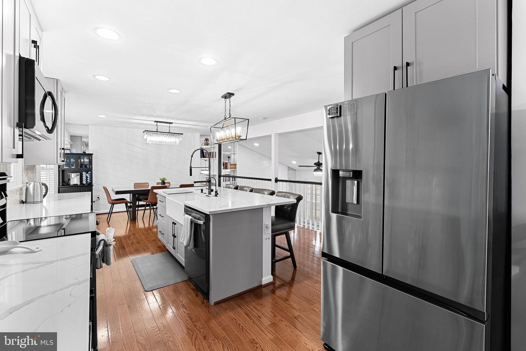 6208 Ormandy Drive Burke, VA 22015 - Photo 18 of 57 a kitchen with stainless steel appliances granite countertop a refrigerator a stove and a sink