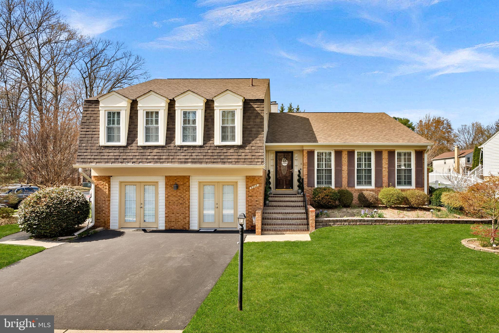 6208 Ormandy Drive Burke, VA 22015 - Photo 2 of 57 a front view of a house with a yard