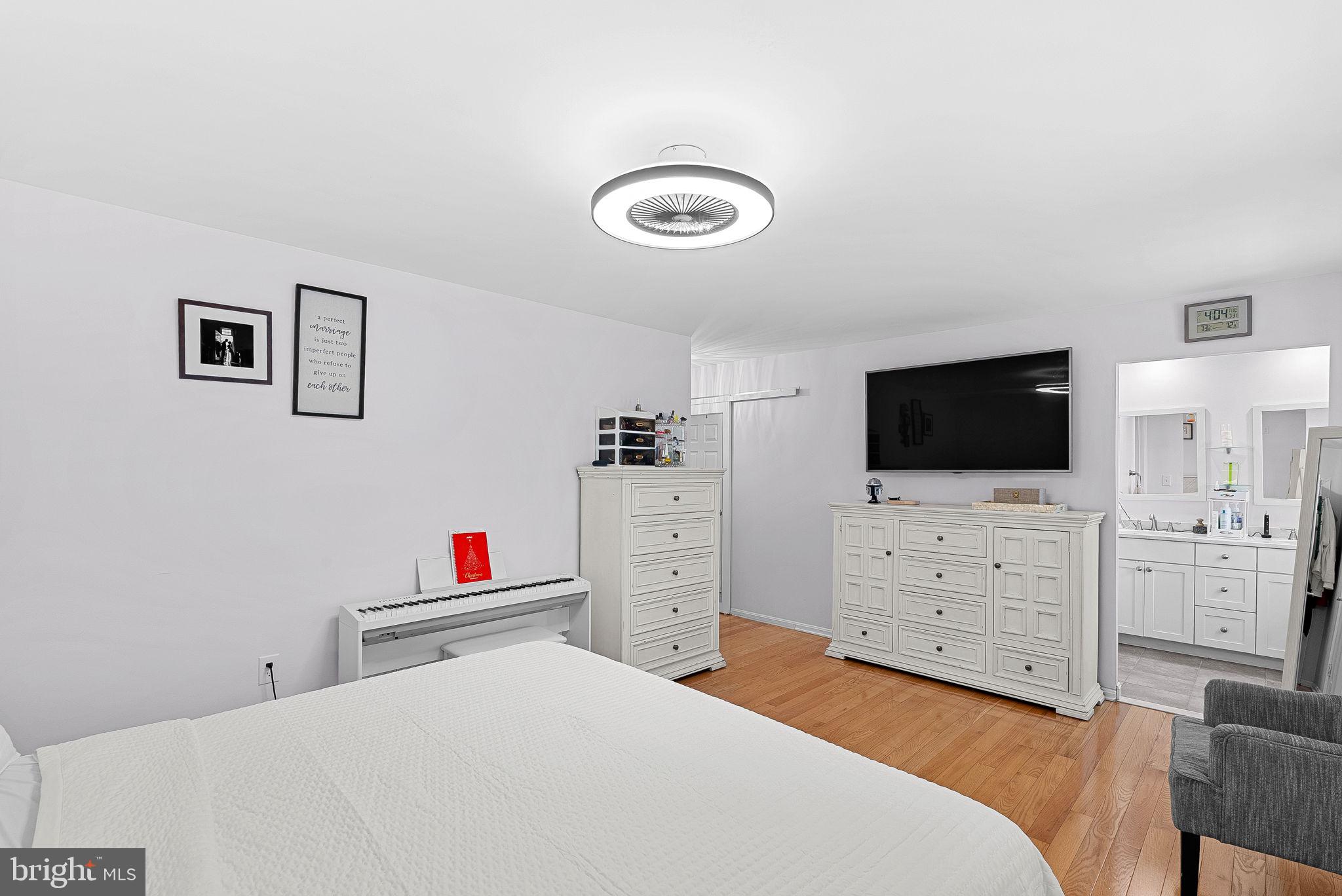 6208 Ormandy Drive Burke, VA 22015 - Photo 23 of 57 a bedroom with a bed and wooden floor