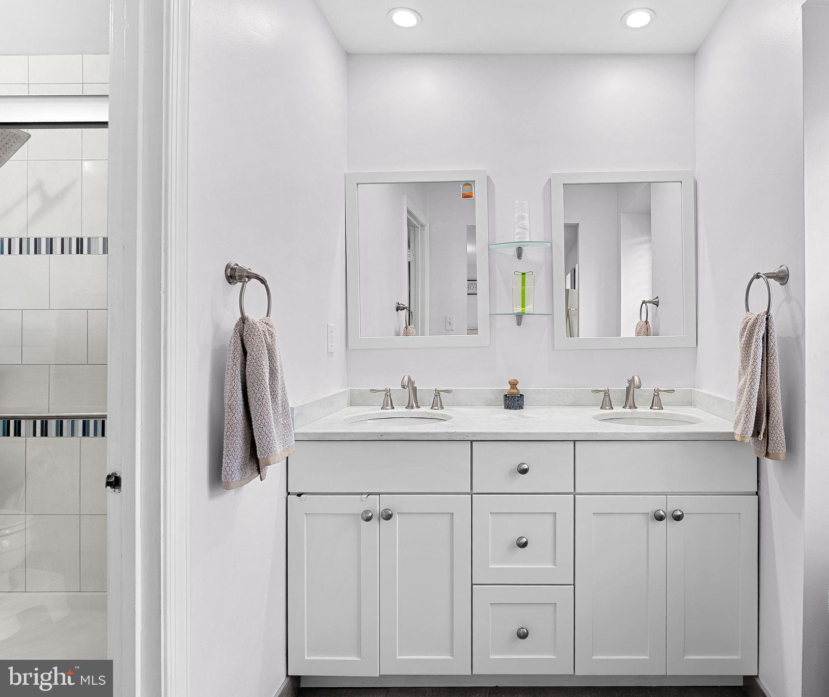 6208 Ormandy Drive Burke, VA 22015 - Photo 26 of 57 a bathroom with a granite countertop sink and a mirror