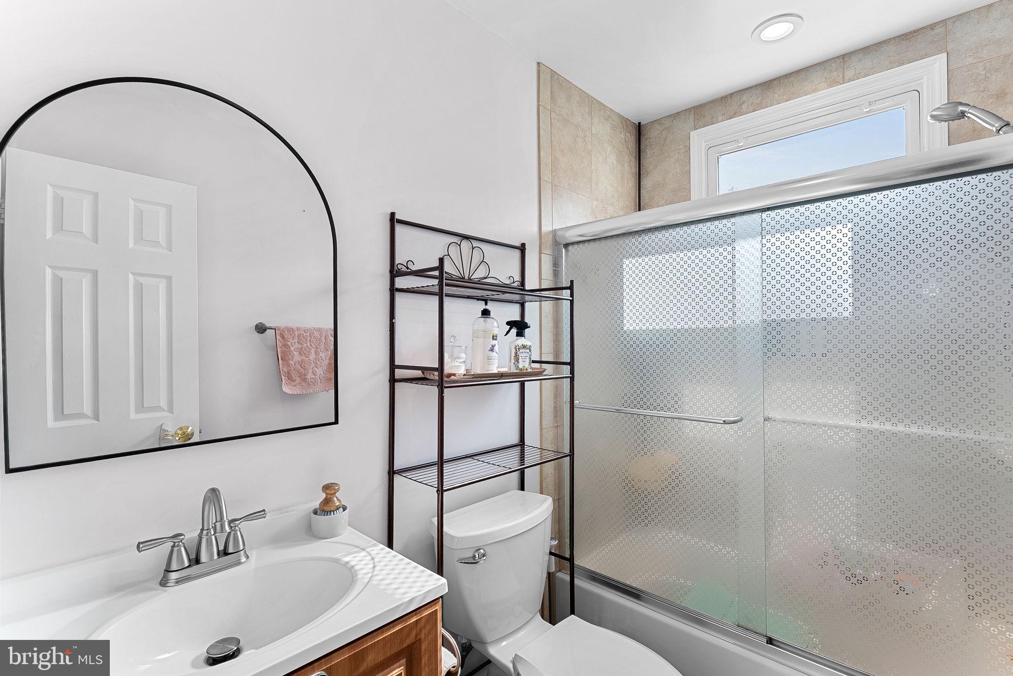6208 Ormandy Drive Burke, VA 22015 - Photo 30 of 57 a bathroom with a sink toilet and shower