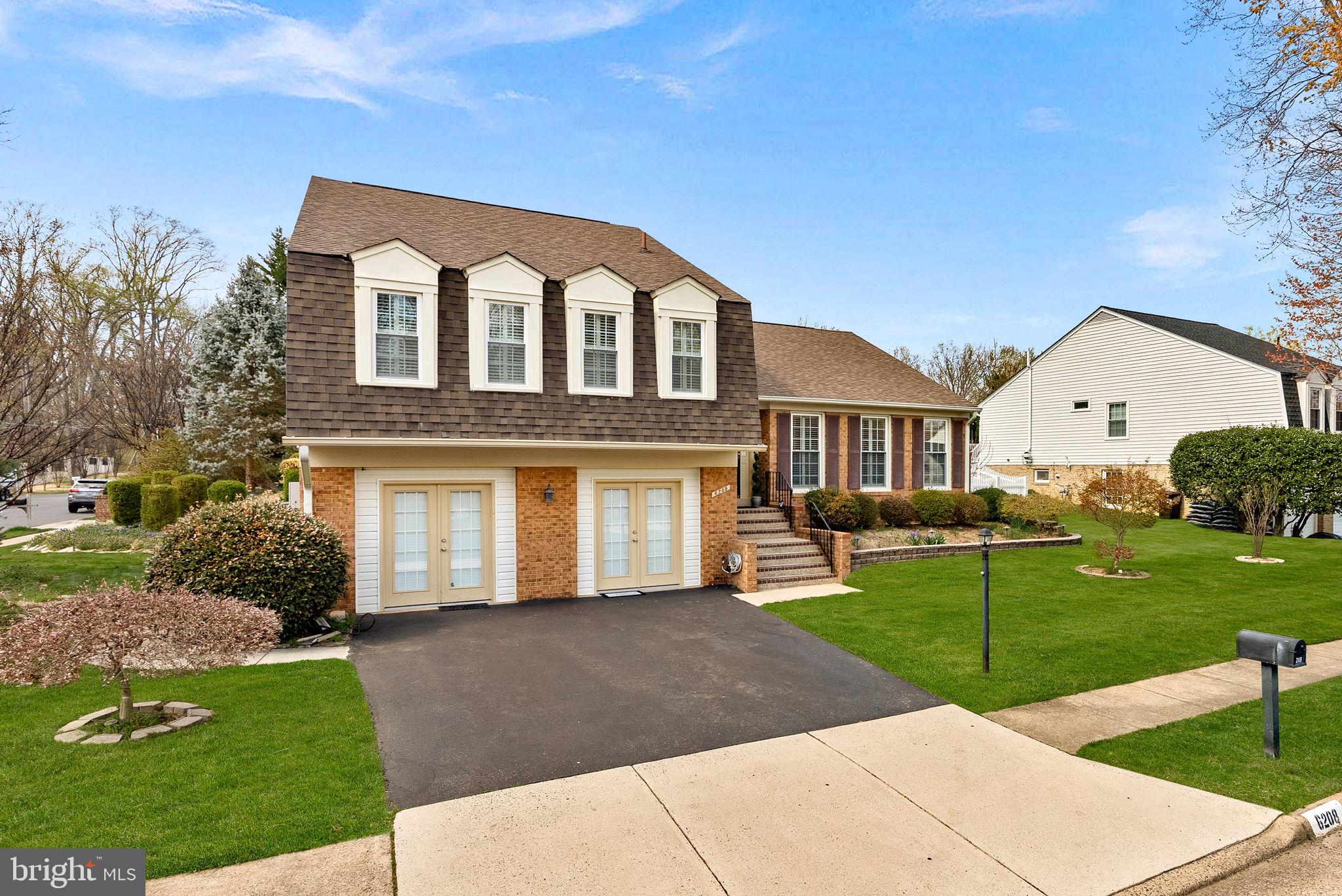 6208 Ormandy Drive Burke, VA 22015 - Photo 3 of 57 a front view of a house with a yard