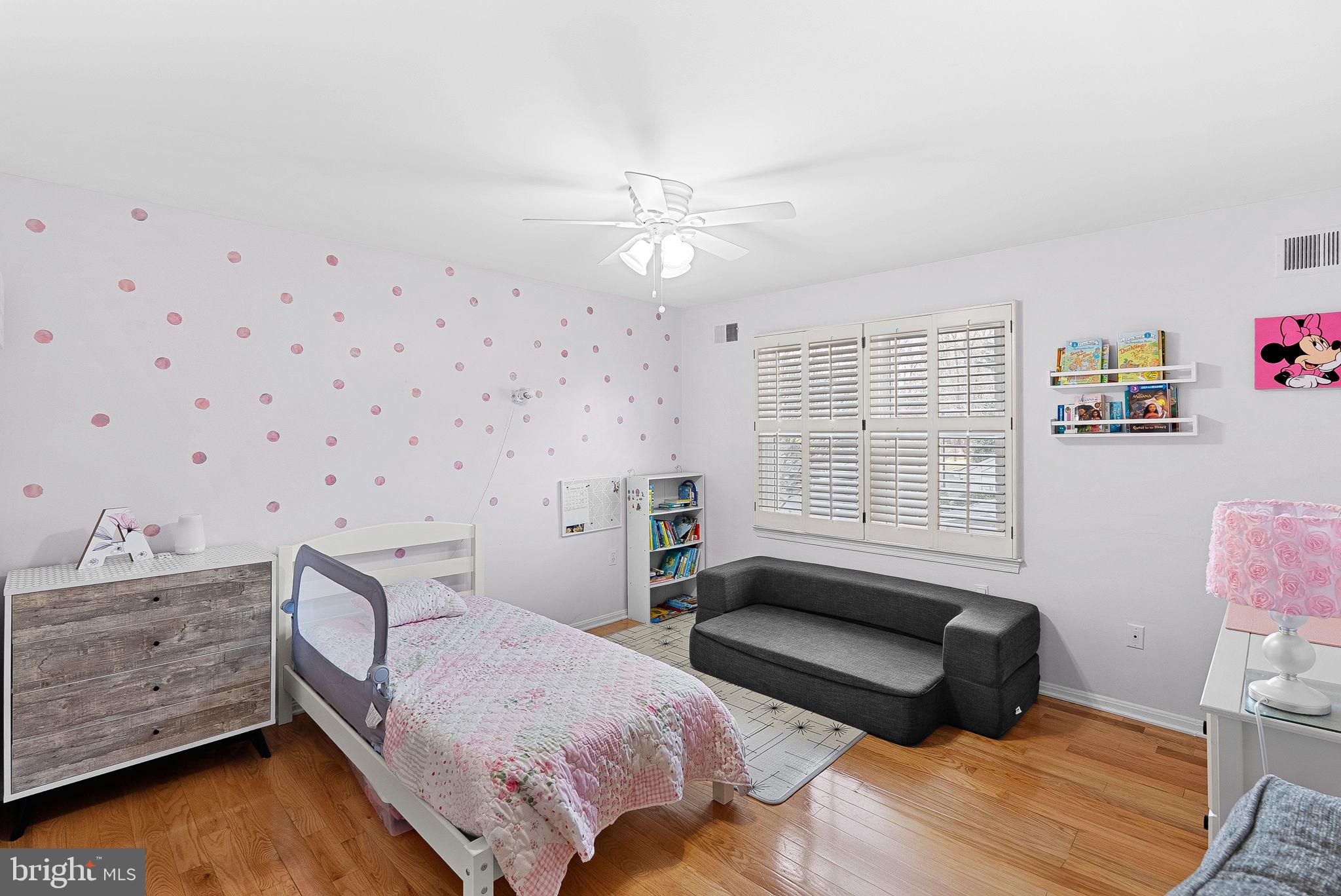 6208 Ormandy Drive Burke, VA 22015 - Photo 31 of 57 a bedroom with a bed wooden floor and window