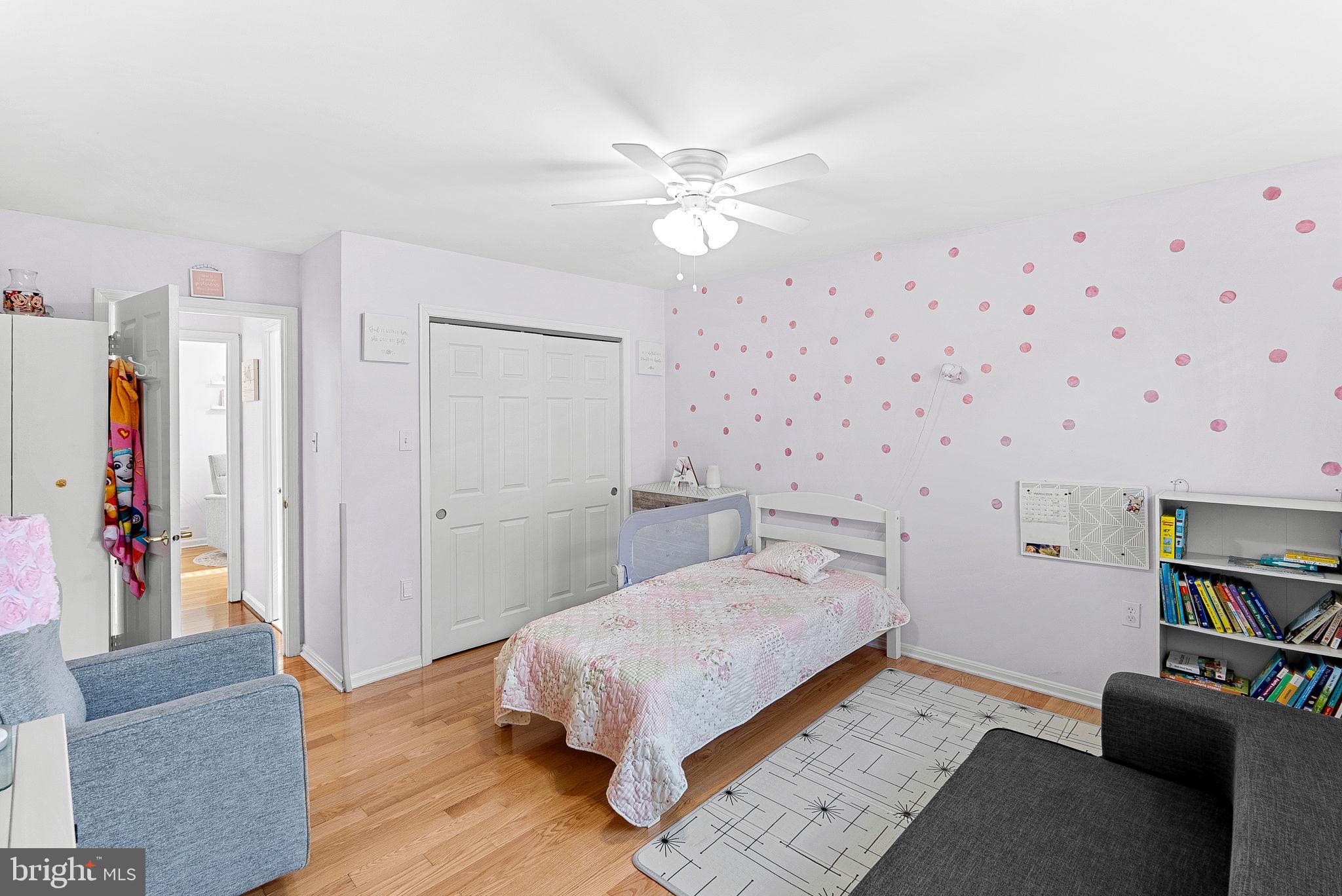 6208 Ormandy Drive Burke, VA 22015 - Photo 32 of 57 a bedroom with a bed and a chandelier