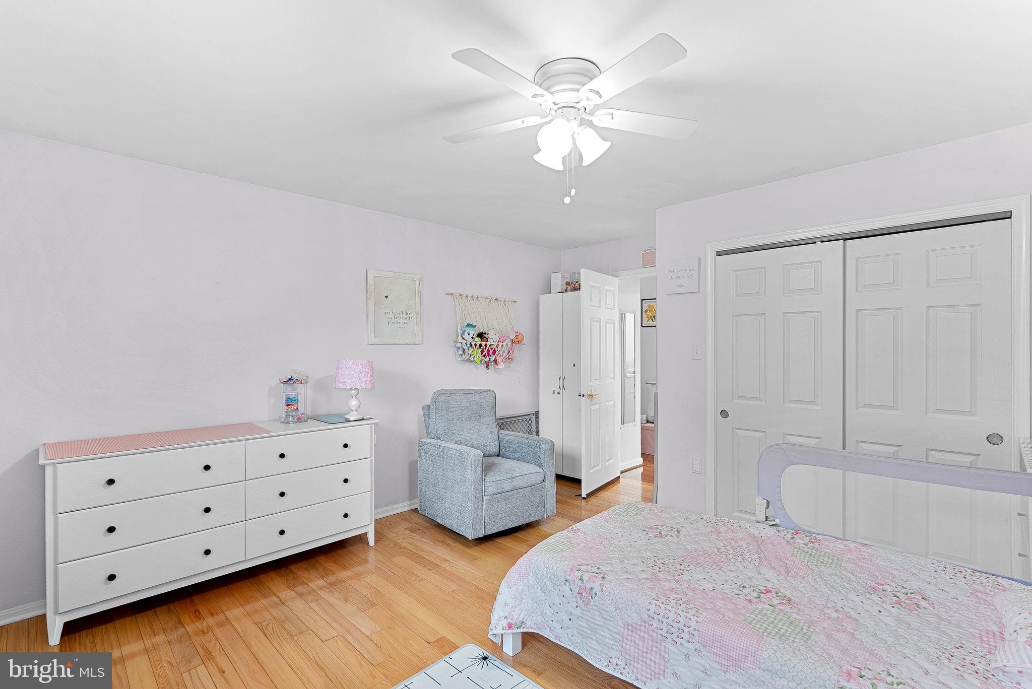 6208 Ormandy Drive Burke, VA 22015 - Photo 33 of 57 a spacious bedroom with a bed and a chandelier