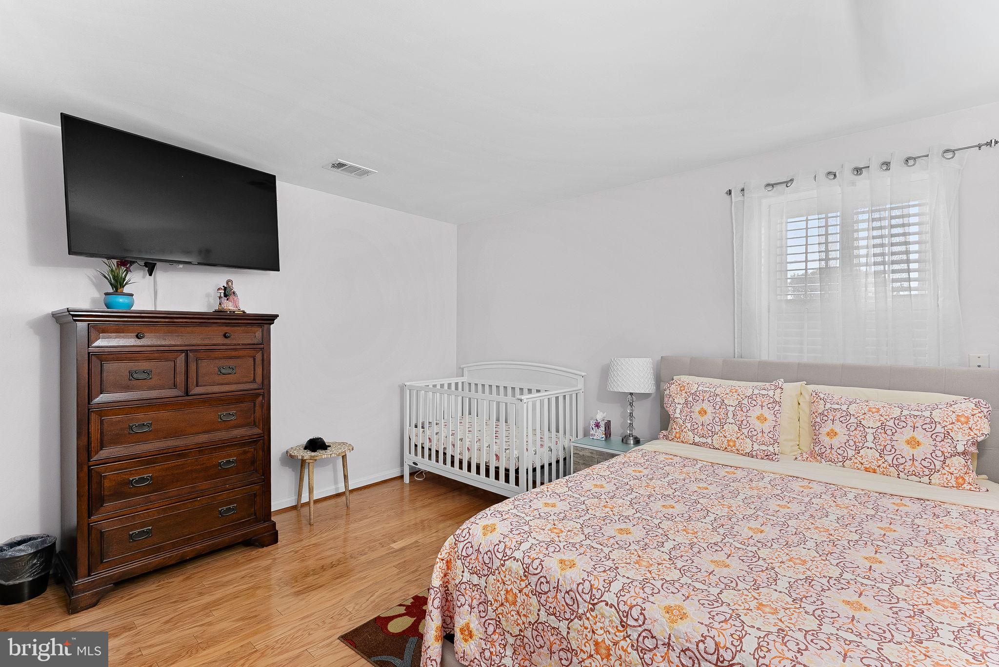 6208 Ormandy Drive Burke, VA 22015 - Photo 36 of 57 a bedroom with a bed and flat screen tv