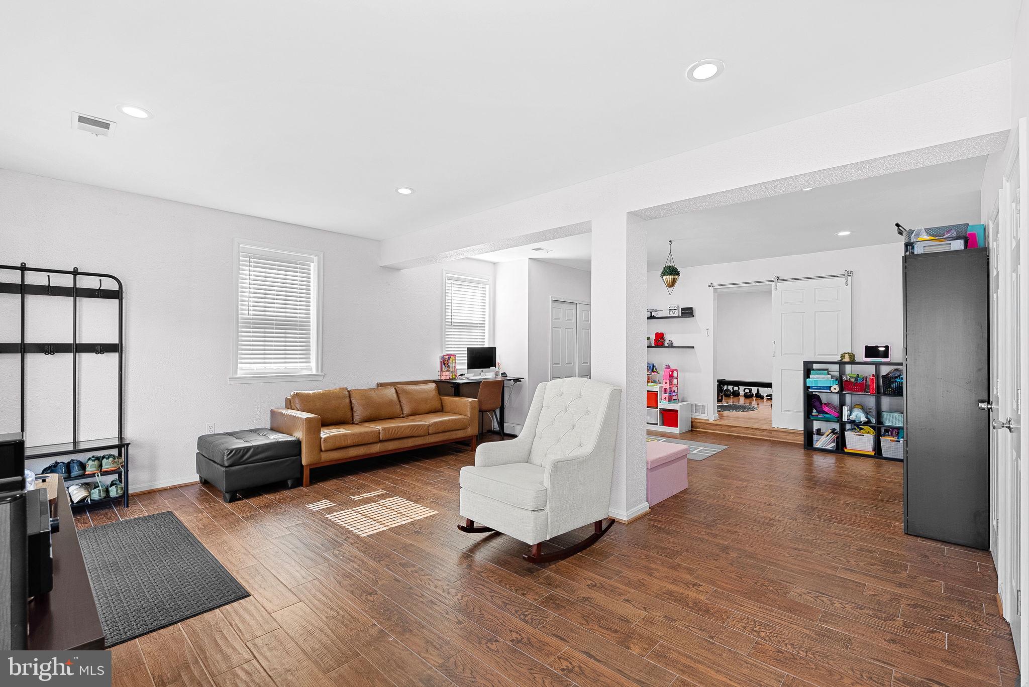 6208 Ormandy Drive Burke, VA 22015 - Photo 41 of 57 a living room with furniture and a wooden floor
