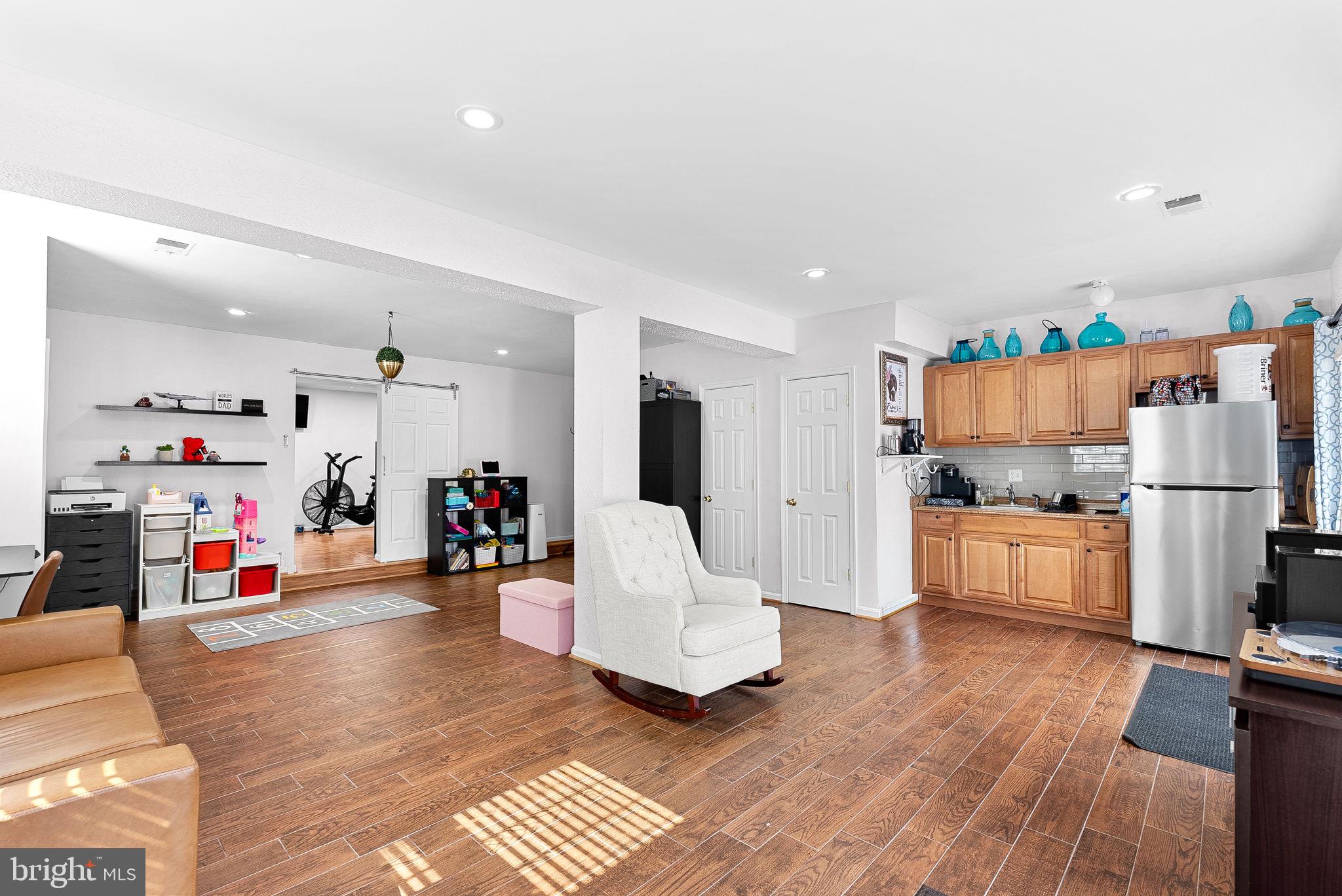 6208 Ormandy Drive Burke, VA 22015 - Photo 42 of 57 a living room with furniture and a wooden floor