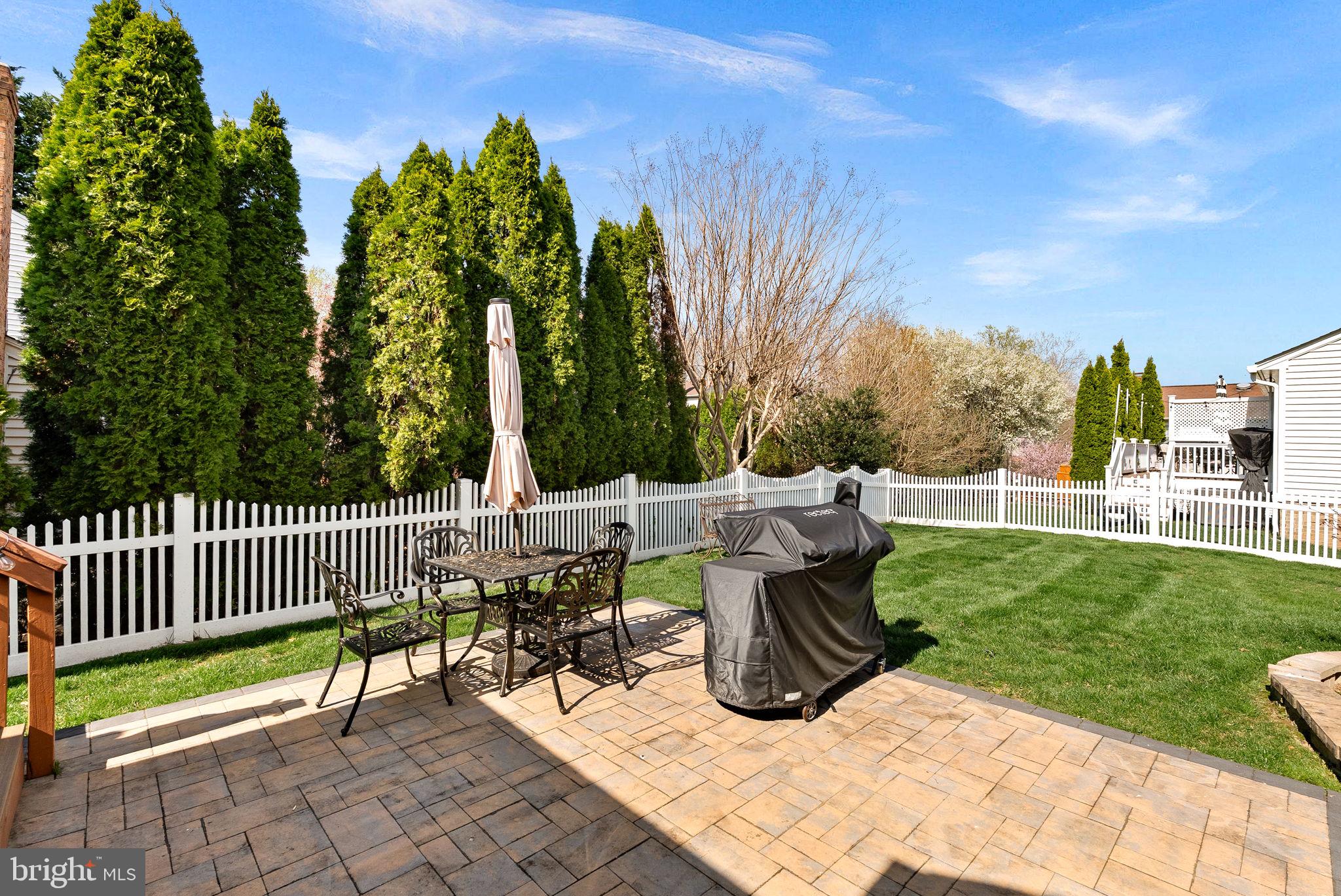 6208 Ormandy Drive Burke, VA 22015 - Photo 50 of 57 a view of a patio with a table and chairs