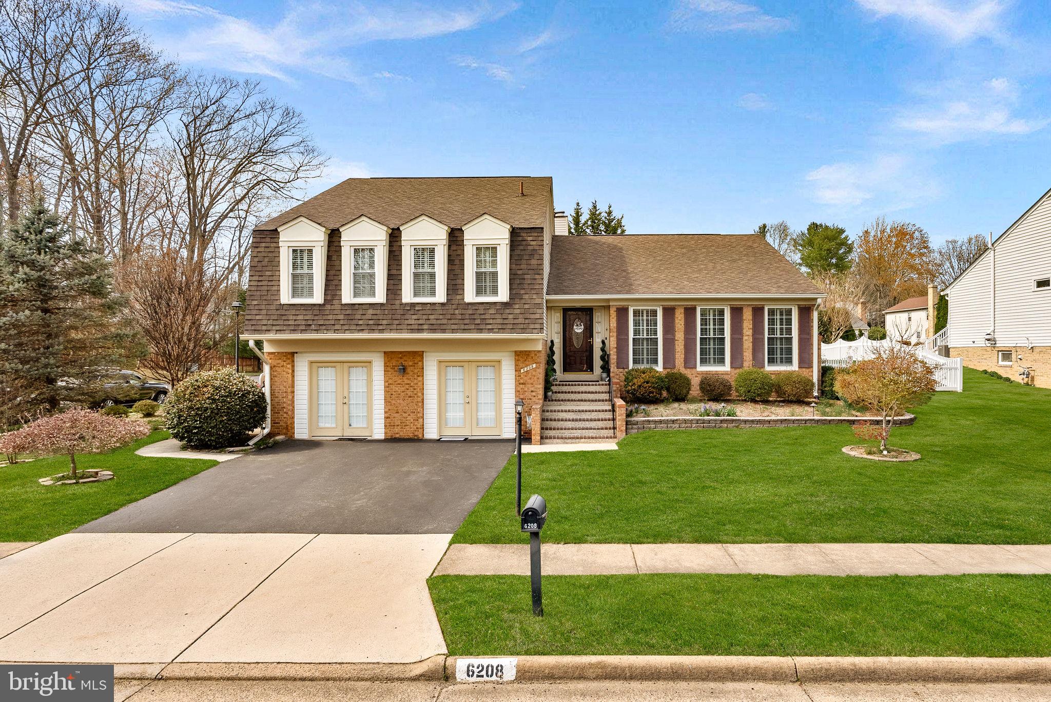 6208 Ormandy Drive Burke, VA 22015 - Photo 54 of 57 a front view of a house with a garden