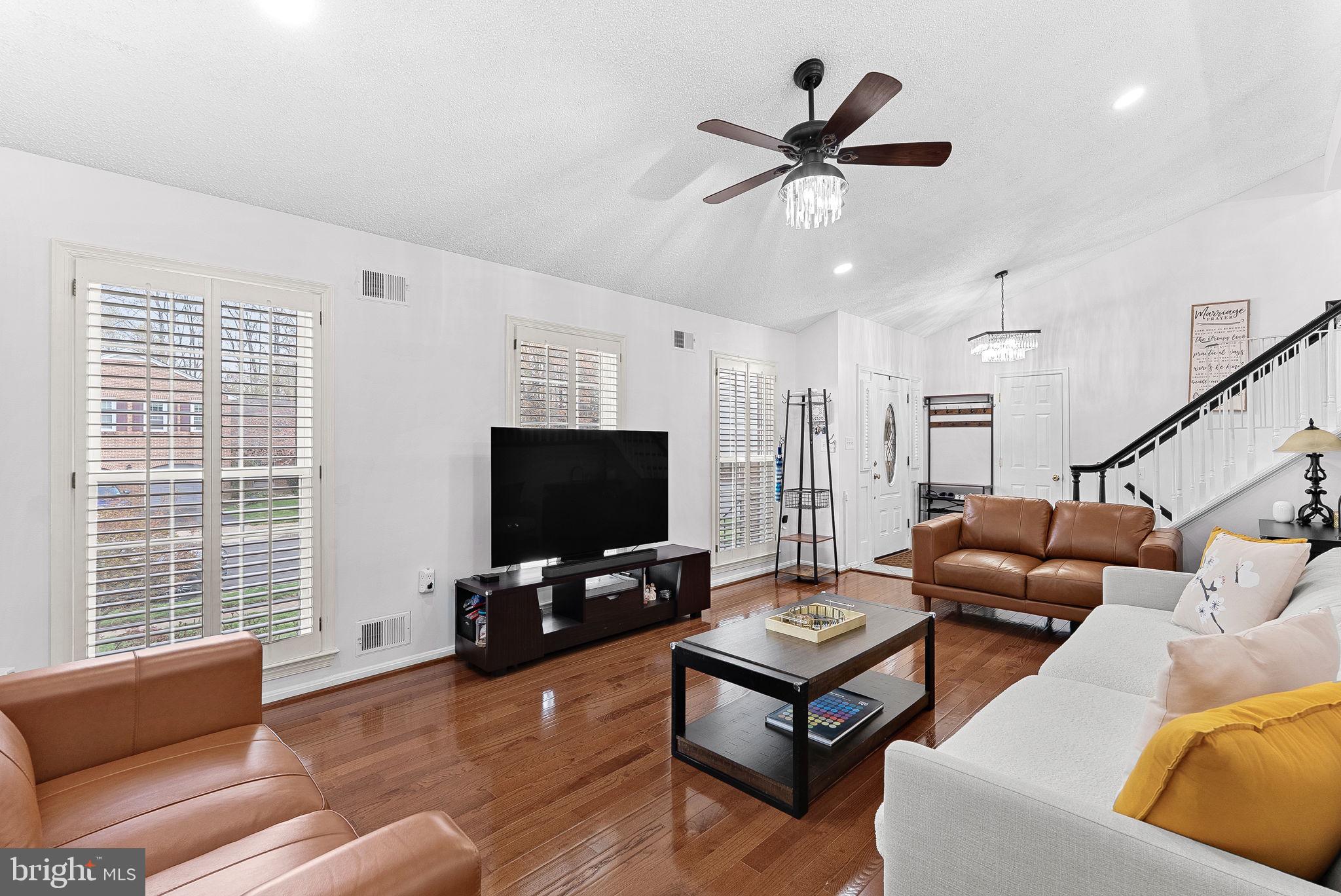 6208 Ormandy Drive Burke, VA 22015 - Photo 7 of 57 a living room with furniture and a flat screen tv with wooden floor