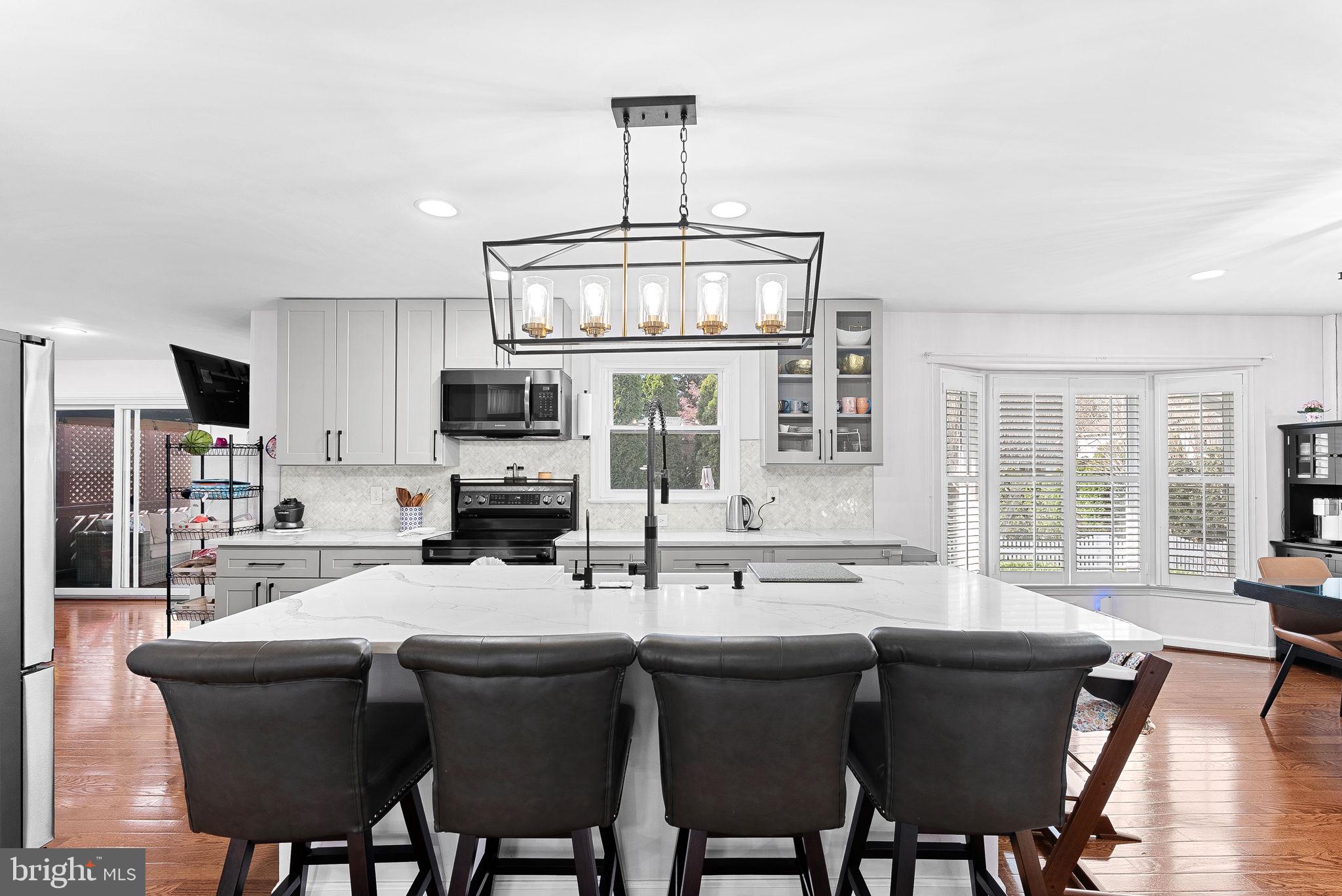 6208 Ormandy Drive Burke, VA 22015 - Photo 10 of 57 a kitchen with stainless steel appliances granite countertop a sink and microwave