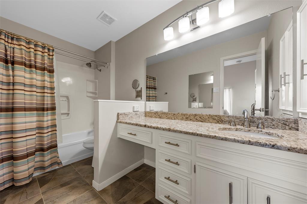 2901 Lake Shore Drive, Unit 405 Waco, TX 76708 - Photo 24 of 31 a bathroom with a granite countertop sink mirror vanity and toilet