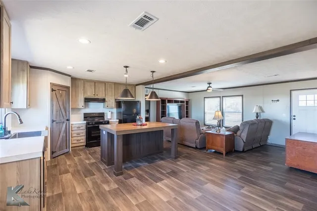 a view of kitchen with sink and refrigerator