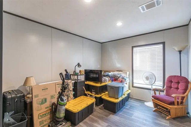 a living room with furniture a flat screen tv and a window
