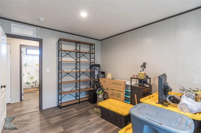 a bedroom with furniture and a wooden floor