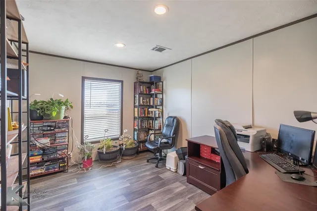 a view of a workspace with furniture and a window