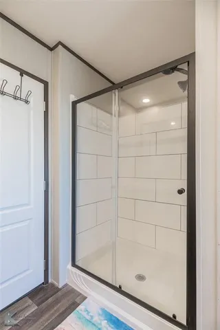 a bathroom with a glass shower door