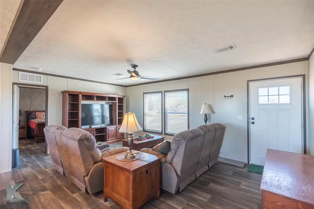 a living room with furniture and large windows