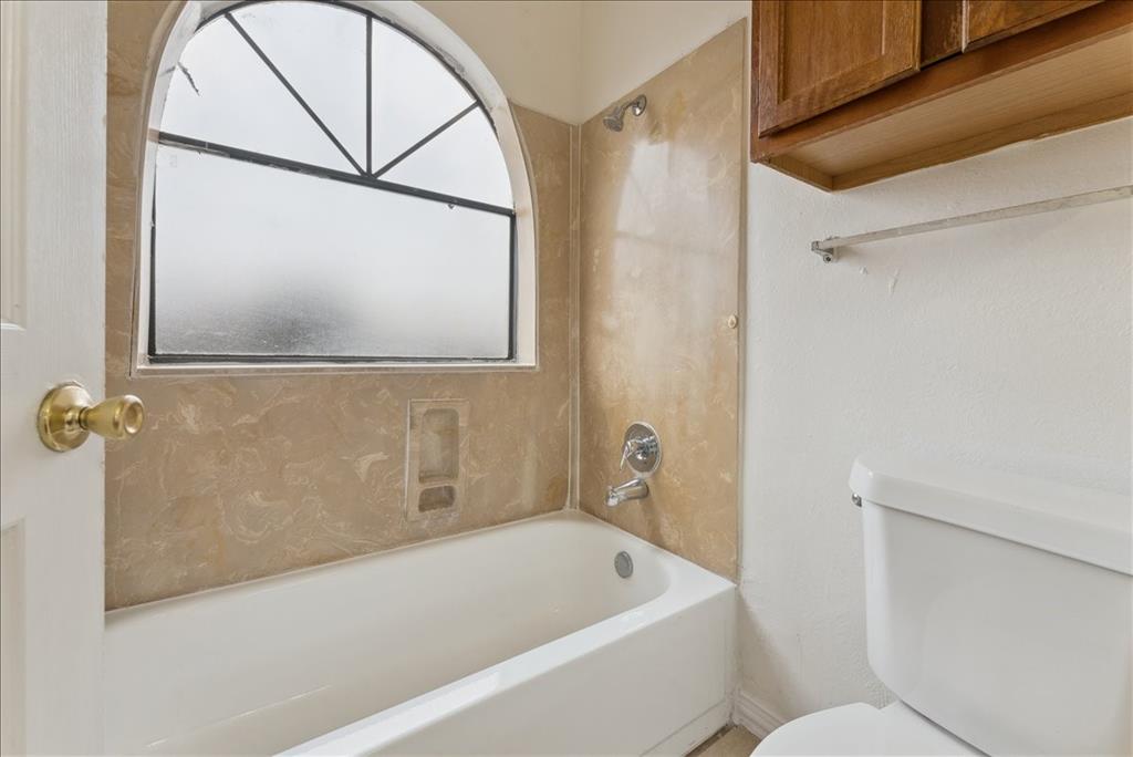 6108 Abrams Road, Unit 330 Dallas, TX 75231 - Photo 14 of 18 a bathroom with a bathtub and a shower